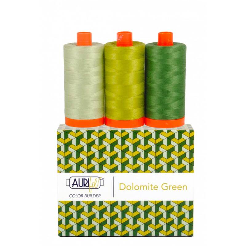 Three spools of threads with shades of green on a Aurifil Color Builder box